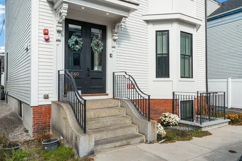 a view of a building with car parked