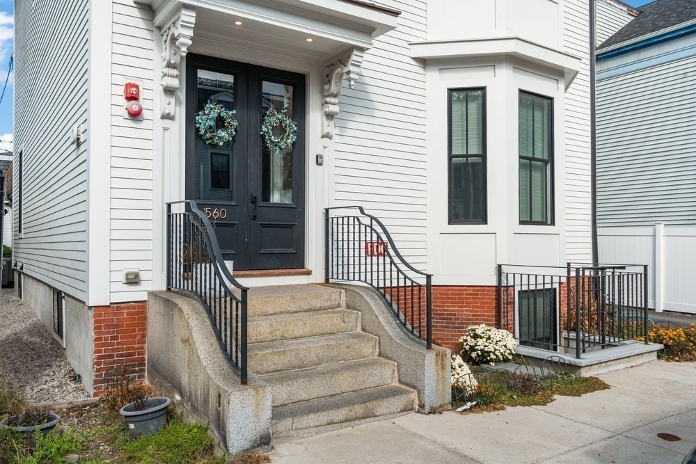 560 East 5th Street, Unit 2 Boston, MA 02127 - Photo 22 of 27 front view of a house with a bench