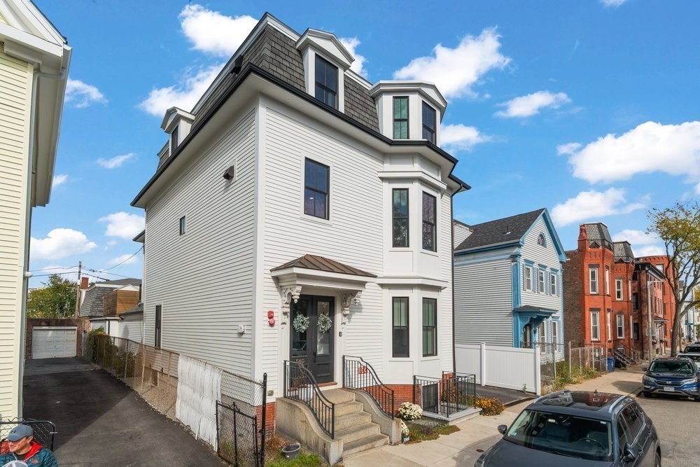 560 East 5th Street, Unit 2 Boston, MA 02127 - Photo 4 of 27 a view of a white building among the street with palm trees