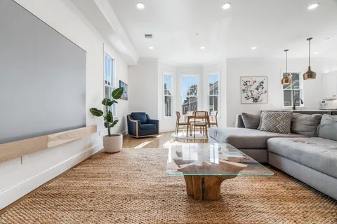 a living room with furniture and a rug