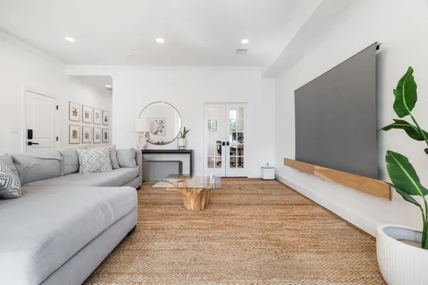 a living room with furniture a rug and a flat screen tv