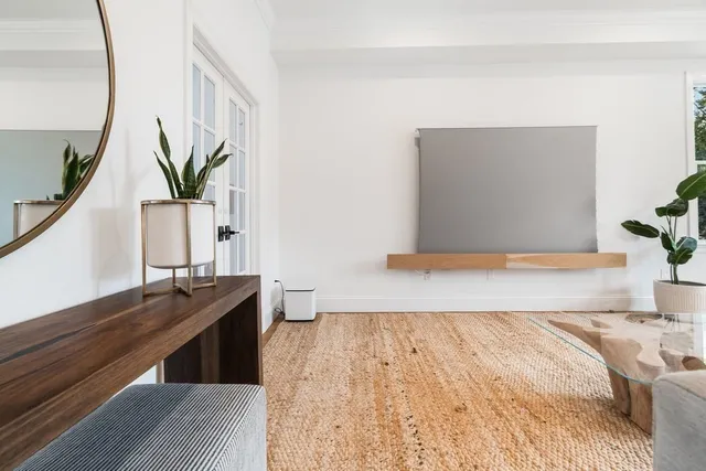 a bedroom with a bed and a potted plant