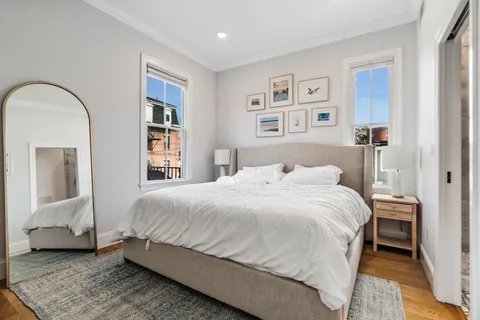 a bedroom with a large bed and a painting