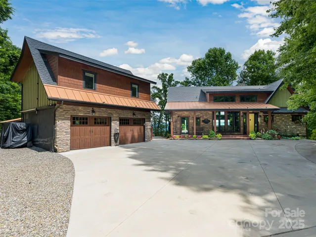 a front view of a house with yard and parking