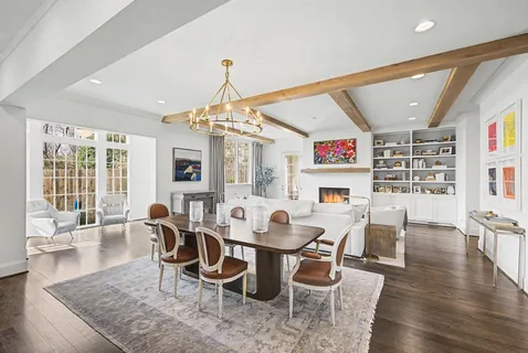 a view of a dining room with furniture wooden floor and chandelier