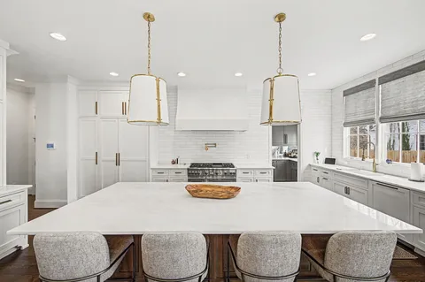 a kitchen with stainless steel appliances granite countertop a stove and a sink