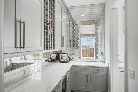 a view of a hallway with wooden floor and furniture