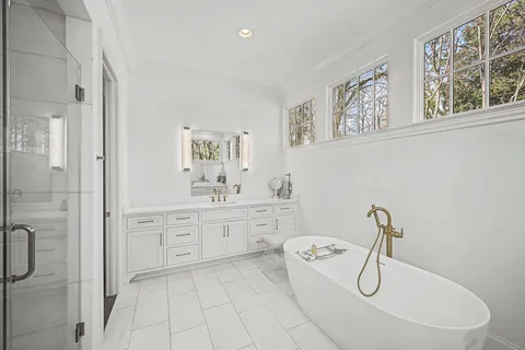 a living room with furniture a chandelier and a painting