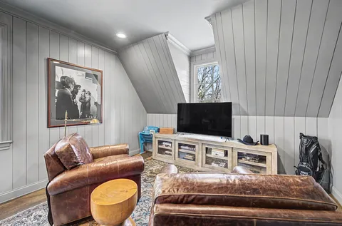a living room with furniture a rug and a window