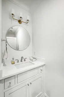 a bathroom with a double vanity sink and mirror