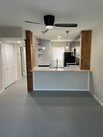 a view of a kitchen with a sink and refrigerator
