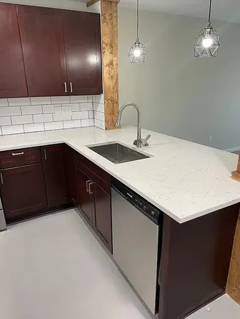 a kitchen with a sink cabinets and stainless steel appliances