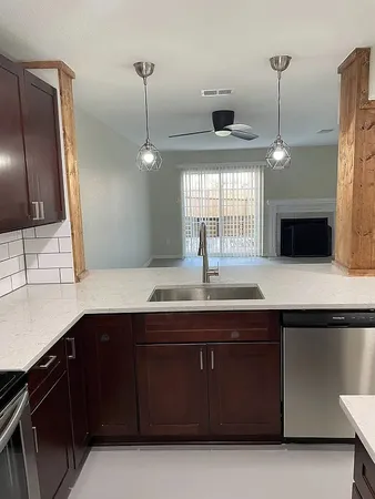 a kitchen with a sink and a refrigerator