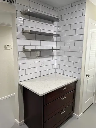 a kitchen with stainless steel appliances a refrigerator a sink a stove and a wooden floors