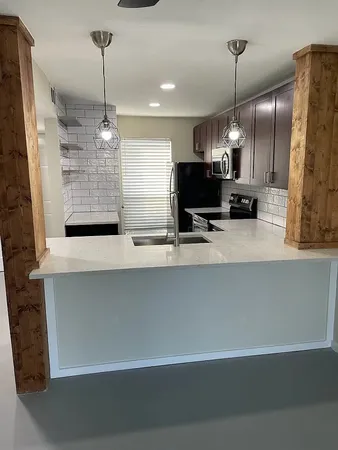 a kitchen with refrigerator and window