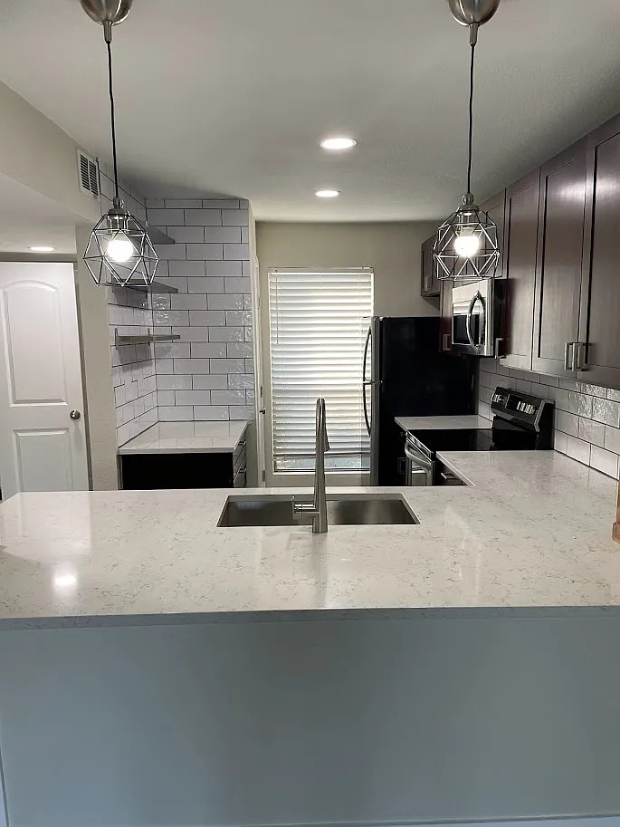 2018 West Rundberg Lane, Unit 16C Austin, TX 78758 - Photo 8 of 12 a kitchen with refrigerator and window