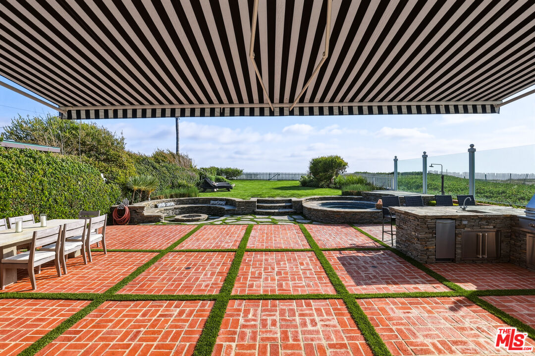 30810 Broad Beach Road Malibu, CA 90265 - Photo 52 of 55 a backyard of a house with table and chairs