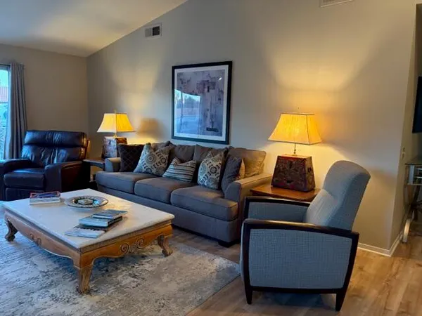 a living room with furniture and a fireplace
