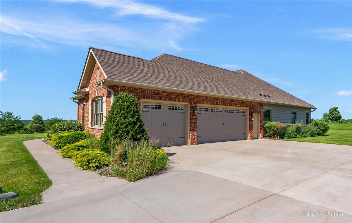 7306 Bob-O-Link Road Spring Grove, IL 60081 - Photo 9 of 14 a front view of a house with a garden