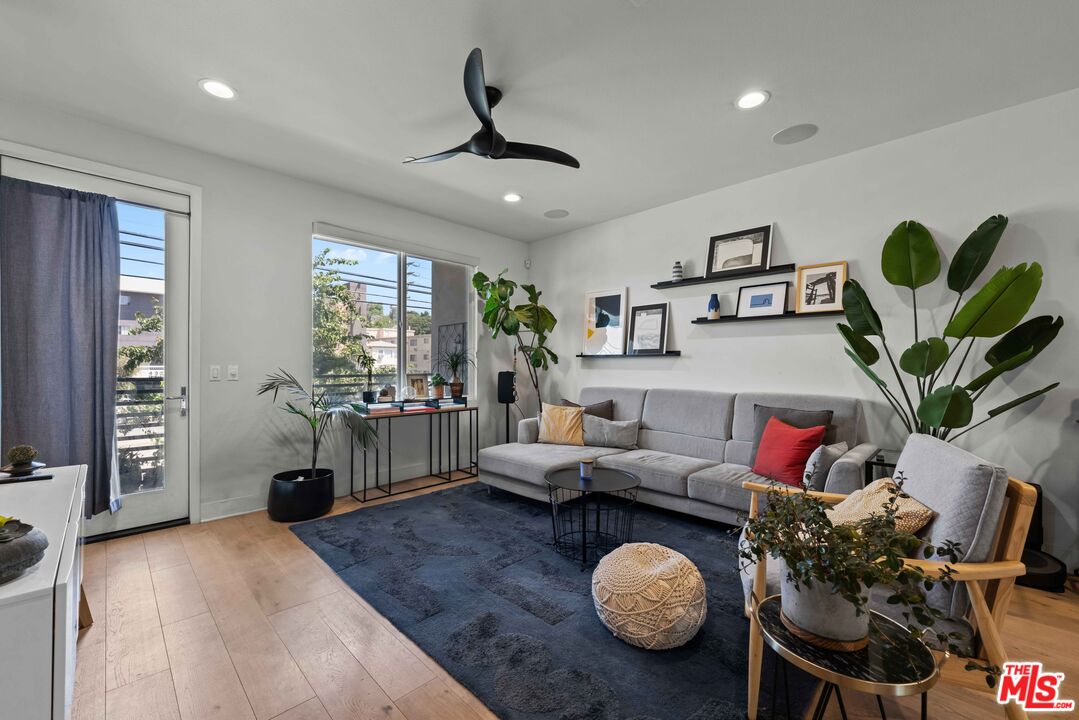 4326 Eagle Rock Boulevard Los Angeles, CA 90041 - Photo 8 of 33 a living room with furniture a chandelier and a wooden floor