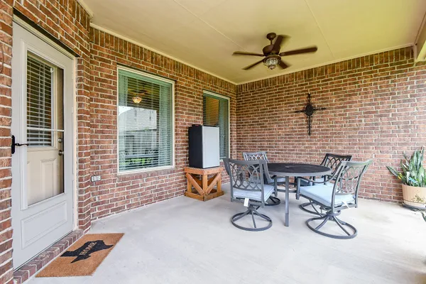 a view of a dinning table and chairs in the patio