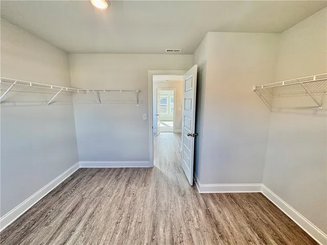 a view of a room with wooden floor and window