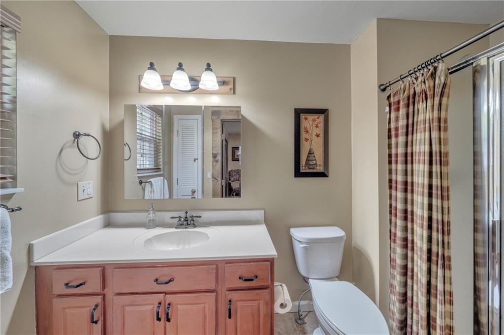 2003 Bend Of The River Road Hiawassee, GA 30546 - Photo 40 of 80 a bathroom with a sink vanity mirror and toilet