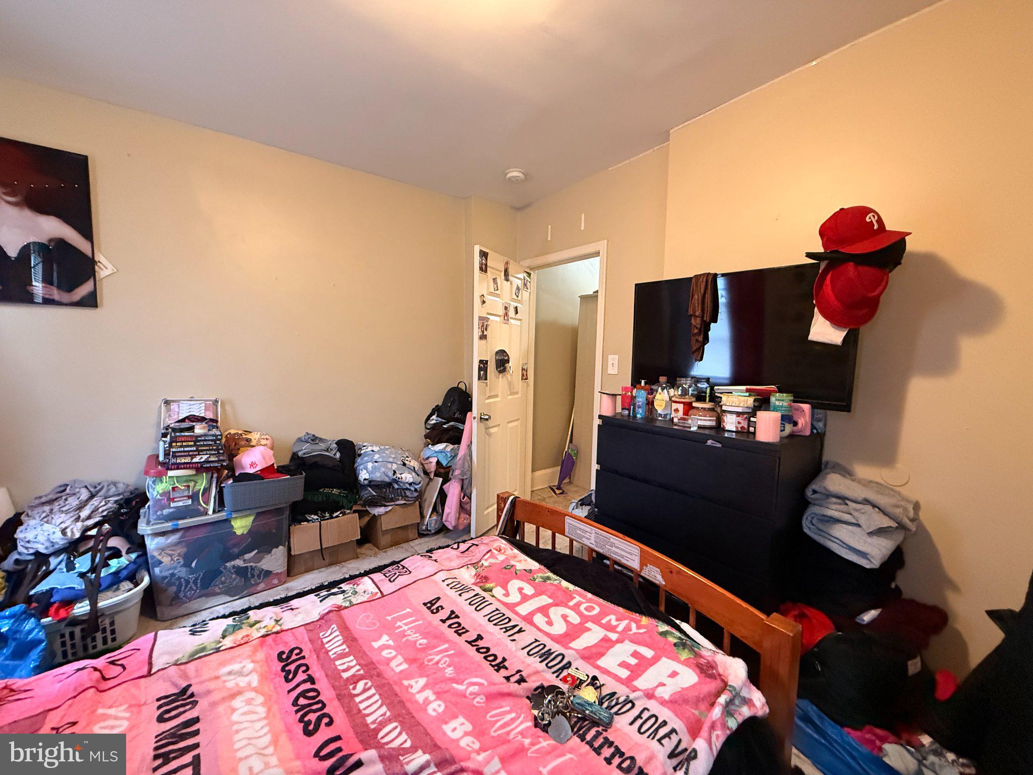 1003 Madison Street Chester, PA 19013 - Photo 21 of 30 a bedroom with a bed and a dresser in it