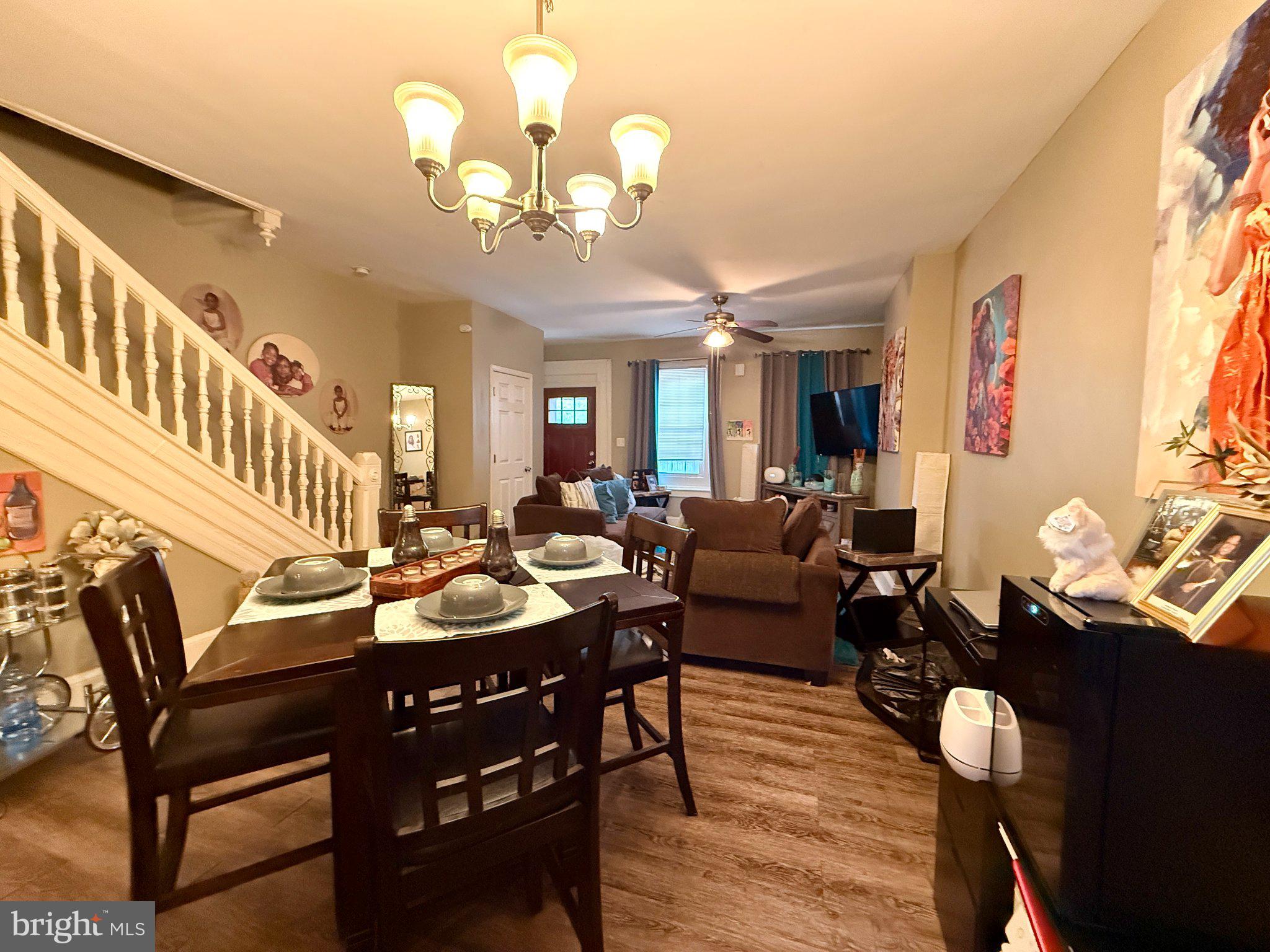 1003 Madison Street Chester, PA 19013 - Photo 3 of 30 a living room with furniture a chandelier and a dining table