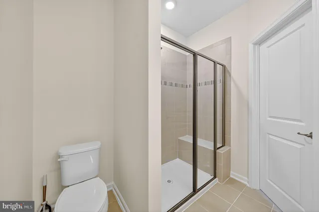 a bathroom with a shower and toilet