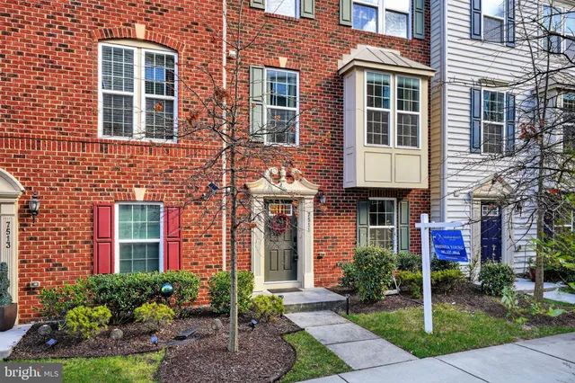 a front view of a house with a garden and plants