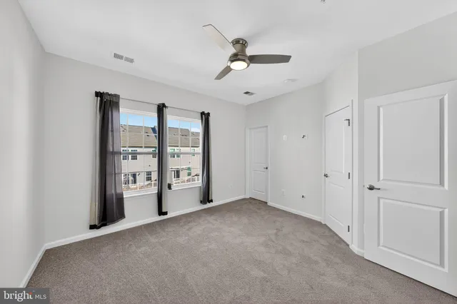 a view of a livingroom with a ceiling fan and window