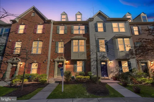 a front view of a residential apartment building with a yard