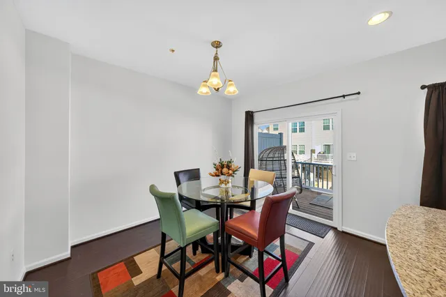 a dining room with furniture a chandelier and wooden floor