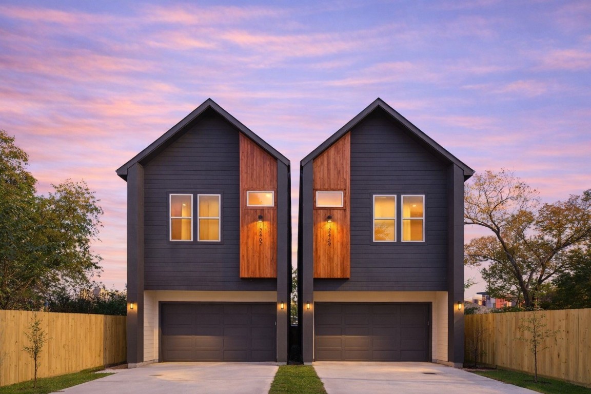 a view of a house with wooden fence