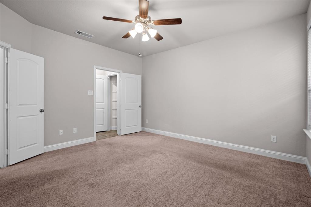 119 Happy Lane Red Oak, TX 75154 - Photo 21 of 37 Spacious room featuring neutral carpet flooring, light gray wall paint, white baseboards, and a ceiling fan with light fixture