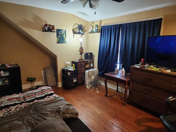a bedroom with a bed and a desk