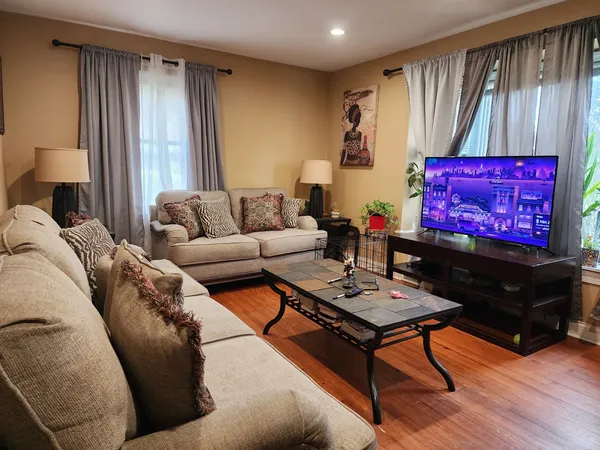 a living room with furniture a rug and a window