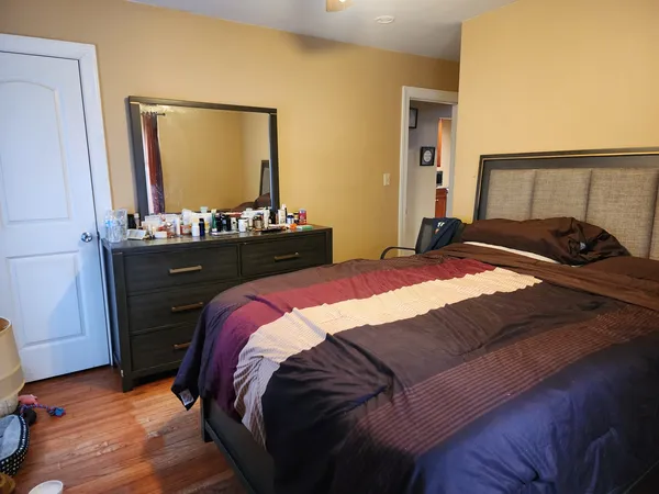 a bedroom with a bed and a mirror