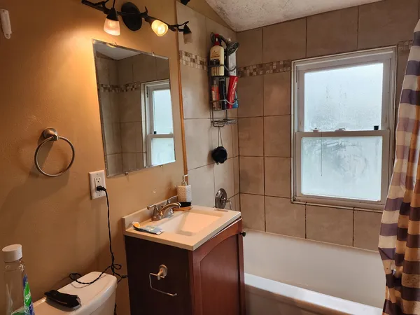 a bathroom with a sink toilet and shower