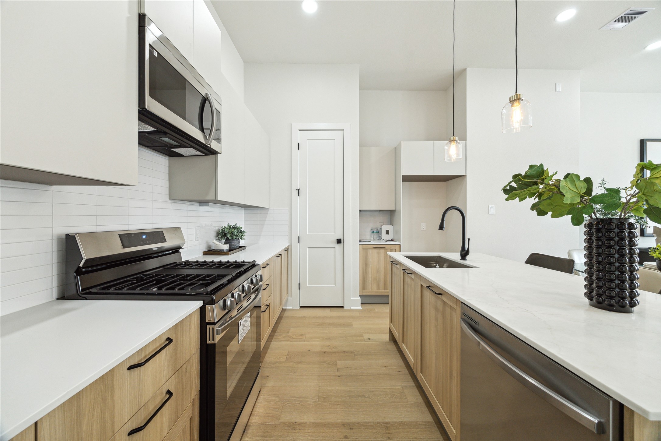 a kitchen with a sink a stove and cabinets
