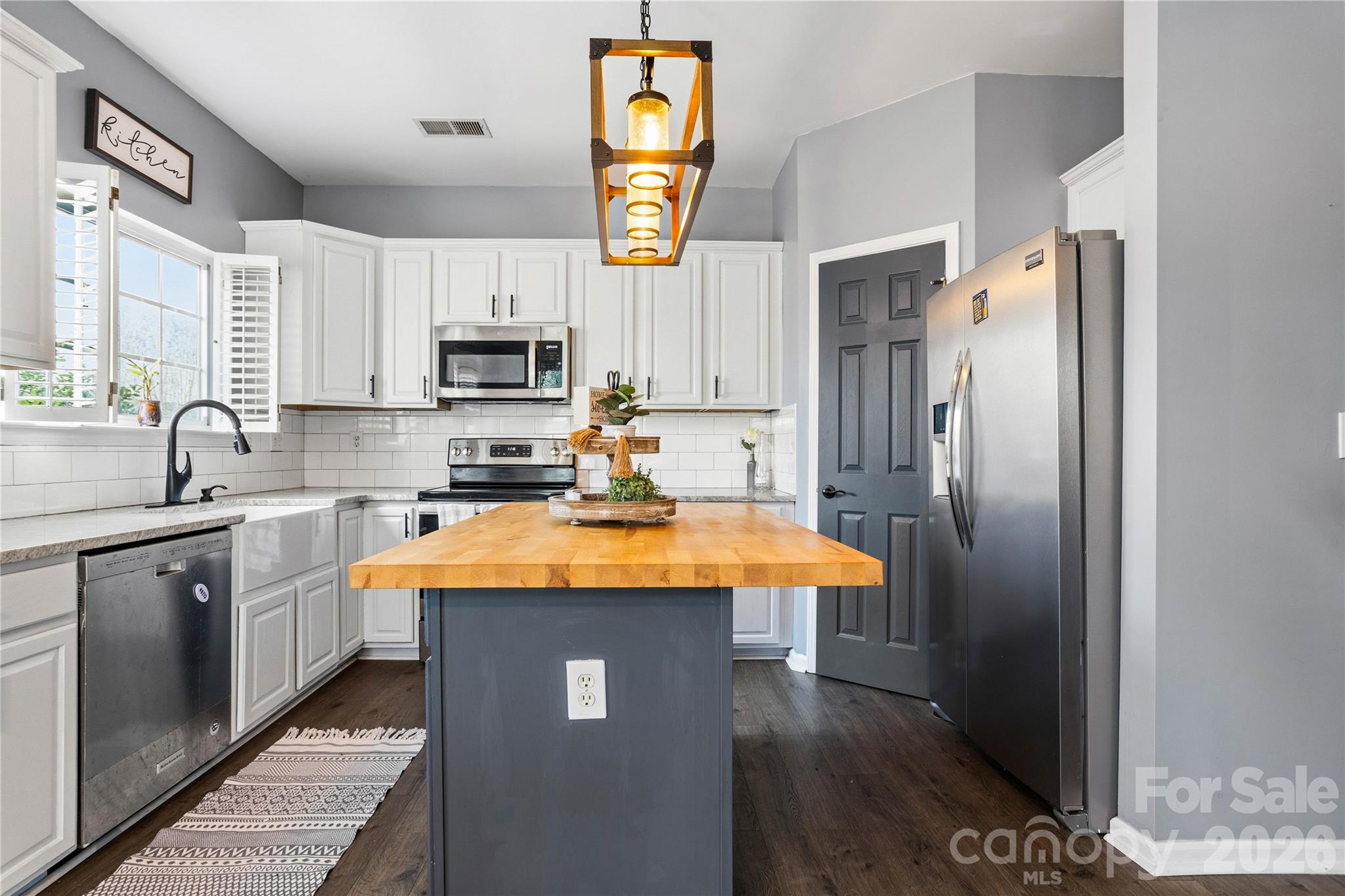 101 Rock Ridge Lane Mount Holly, NC 28120 - Photo 12 of 35 a kitchen with stainless steel appliances granite countertop a refrigerator a stove top oven a sink and dishwasher