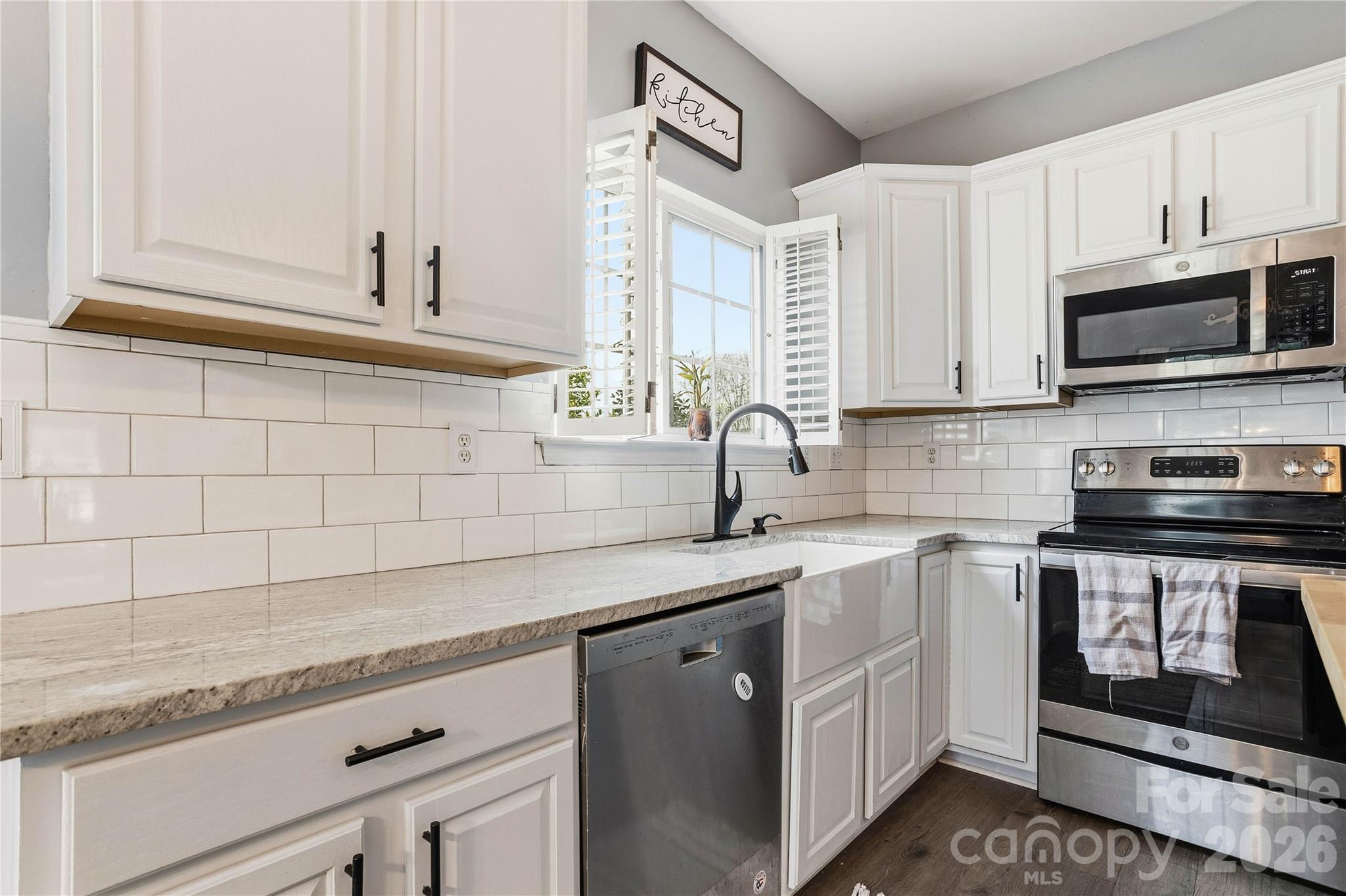 101 Rock Ridge Lane Mount Holly, NC 28120 - Photo 13 of 35 a kitchen with stainless steel appliances granite countertop a sink stove and microwave