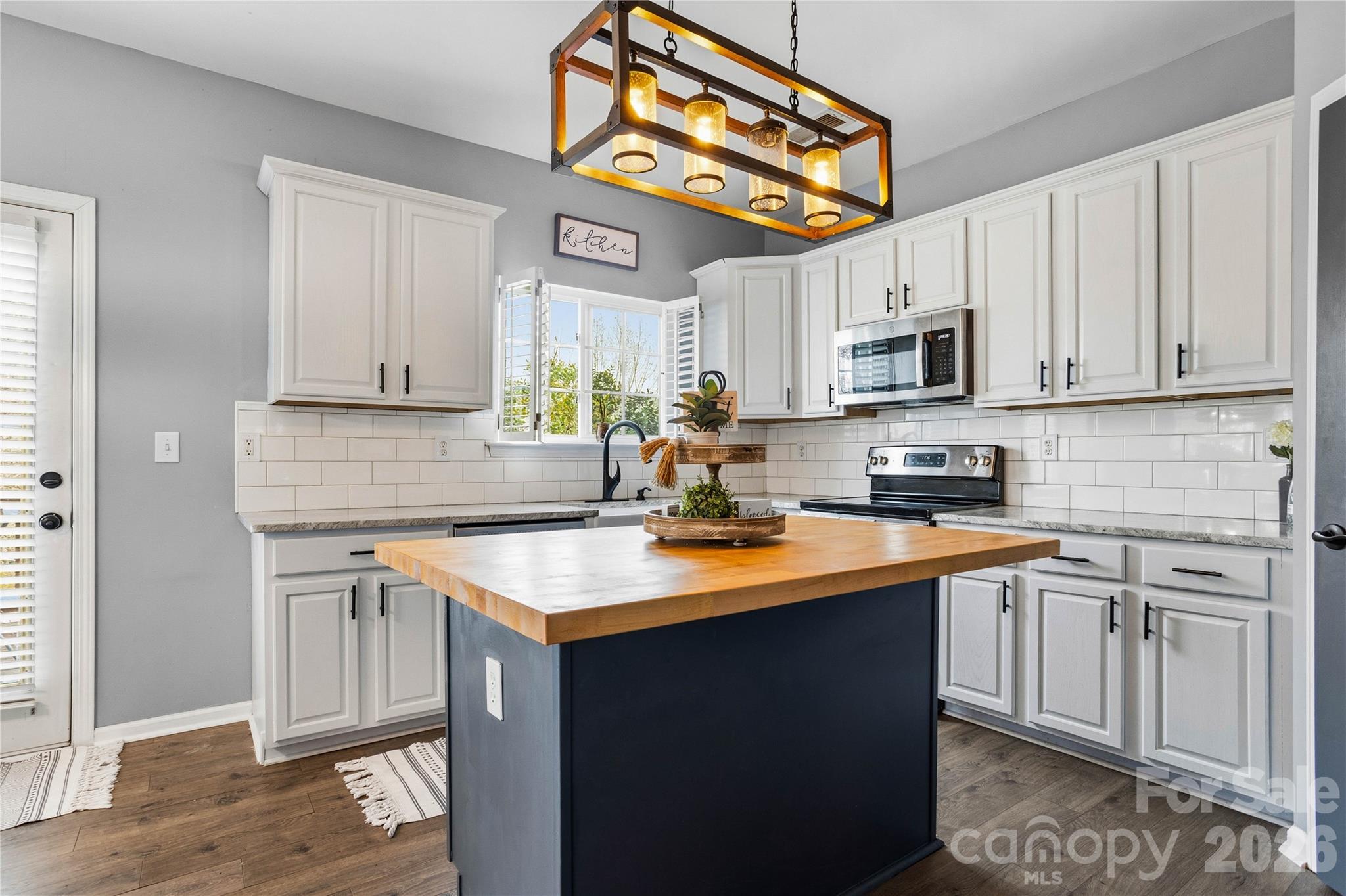 101 Rock Ridge Lane Mount Holly, NC 28120 - Photo 14 of 35 a kitchen with stainless steel appliances granite countertop a sink stove and refrigerator