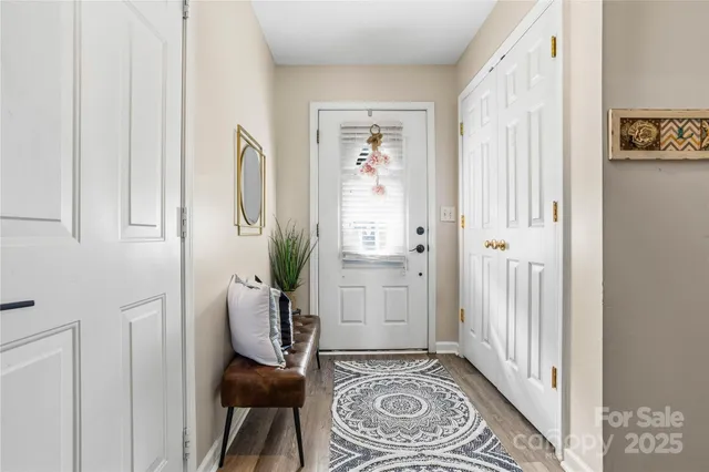 a view of entryway and hall with wooden floor