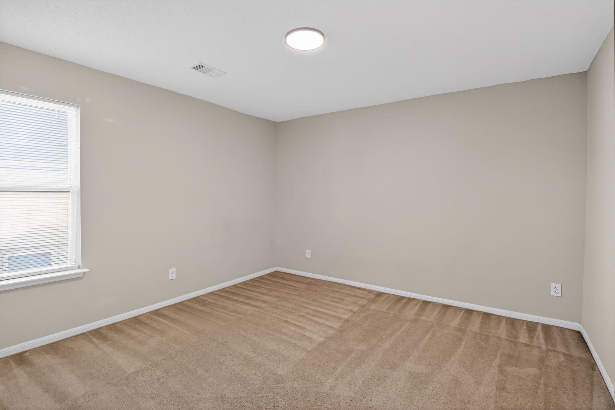 4938 Yearling Ridge Court Katy, TX 77449 - Photo 26 of 29 wooden floor in an empty room with a window