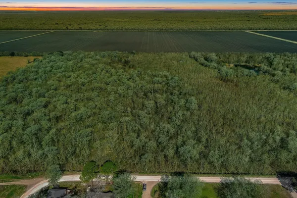 a view of a lake with a yard and trees
