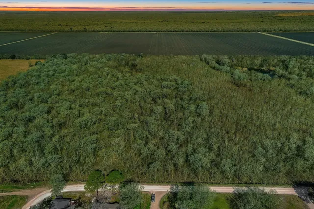 a view of a lake with a yard and trees