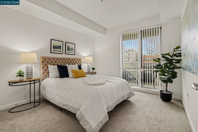 a bedroom with a bed and a potted plant