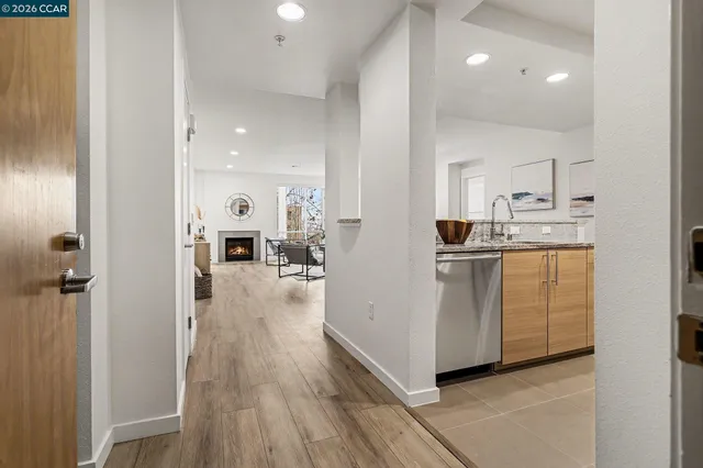 a view of kitchen with sink and refrigerator
